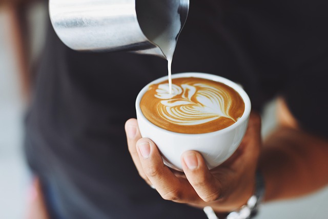 A barista skillfully pouring latte art, demonstrating the craftsmanship at Velvet Roast.
